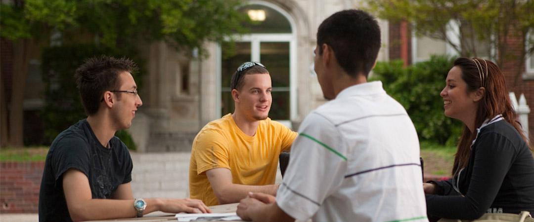 Four students talking outside